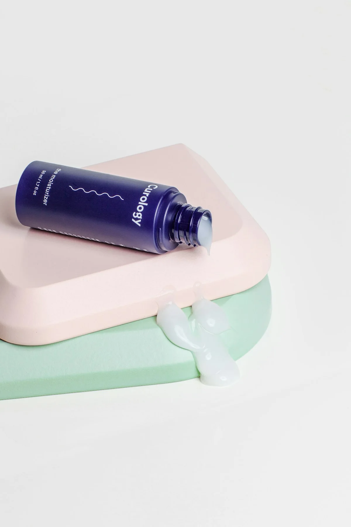 Small toiletries arranged on folded pastel towels